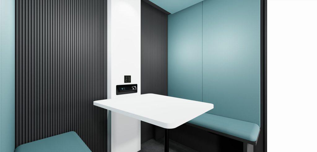 Intérieur cabine acoustique Indus avec table blanche et assises tissu bleu pour espace de travail calme