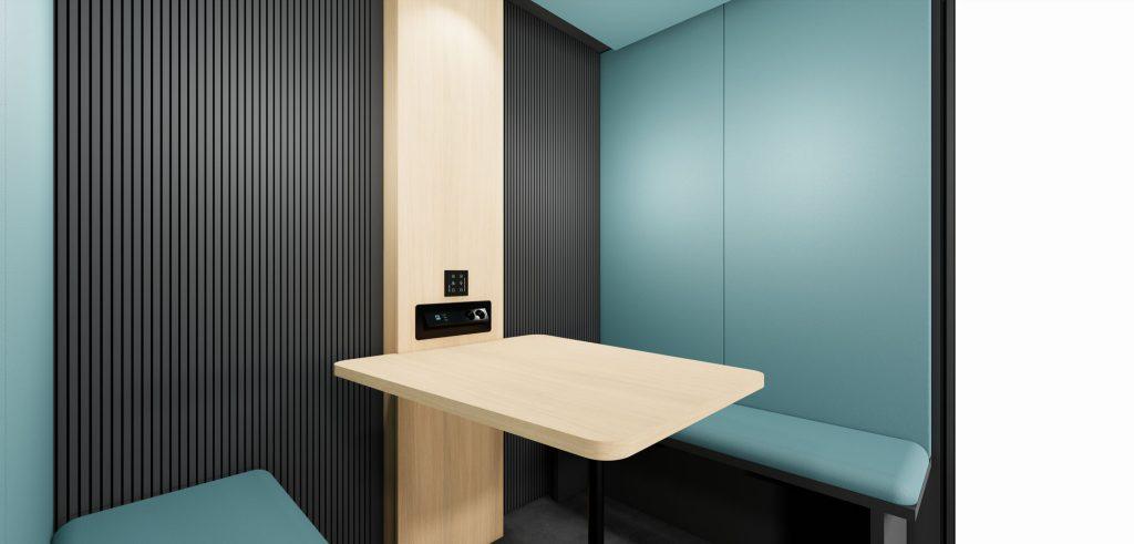 Intérieur cabine acoustique Indus avec table bois clair pour espace de travail chaleureux et acoustique
